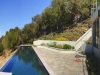 This dramatic vanishing edge pool opens to a grand view. The terraces on the slope are filled with drought tolerant and deer resistant perennials and shrubs. Their strong color does not fade under the intense afternoon sun.